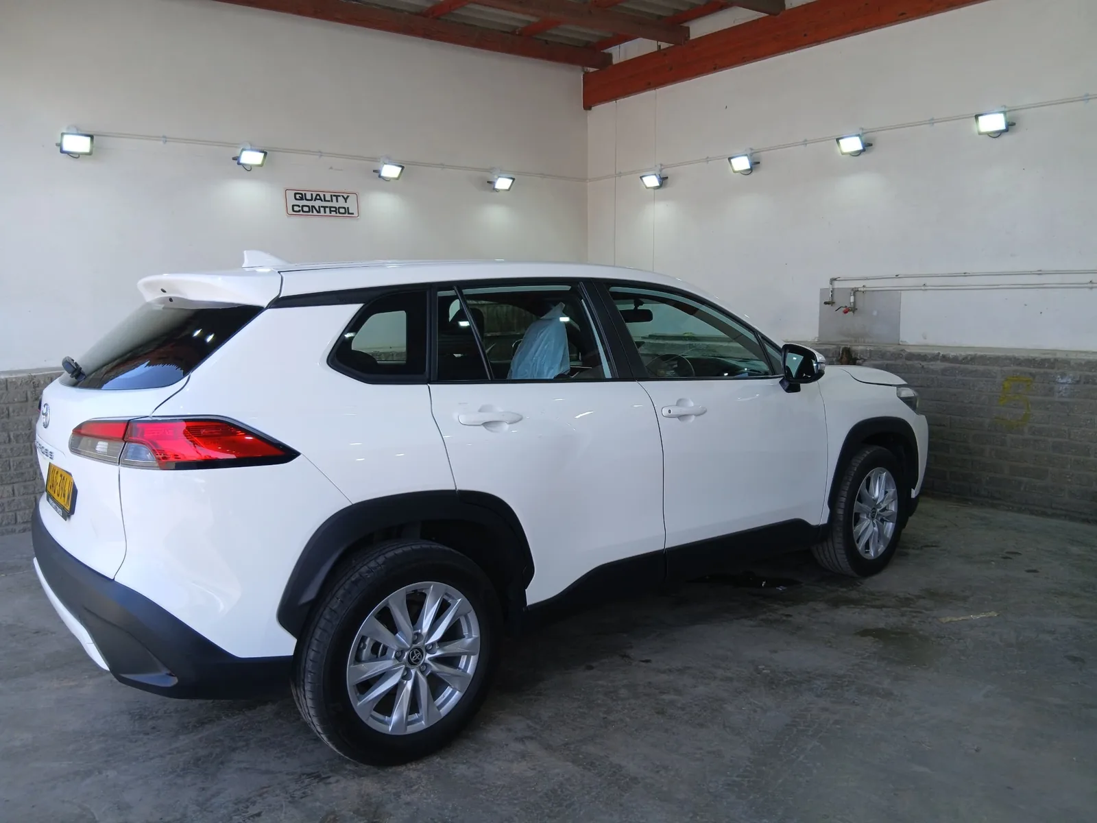 White SUV in the quality control bay